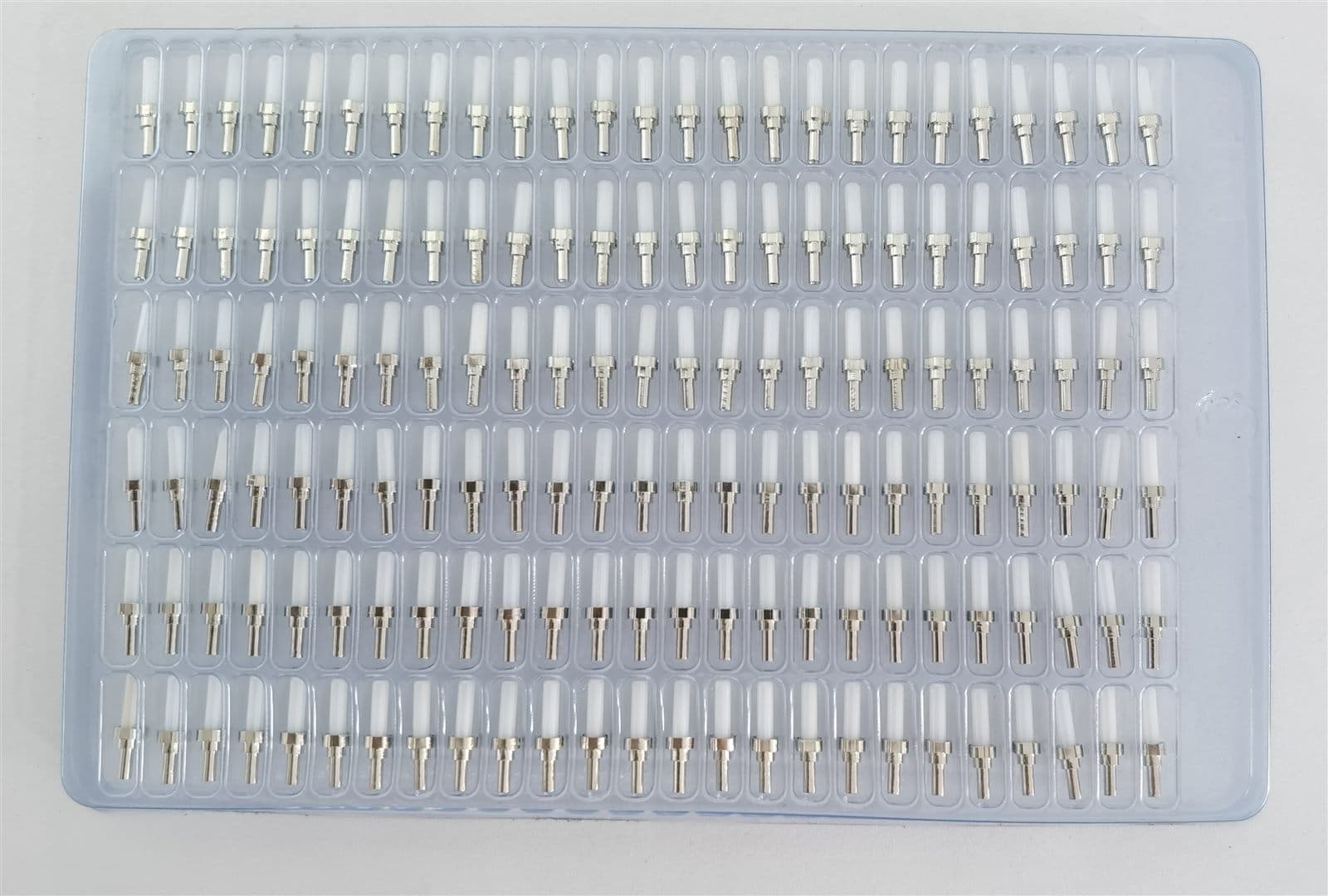 Tray of ceramic ferrules staged for connector assembly in the fibre plant